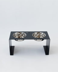 Pet feeding station with two bowls on a white background