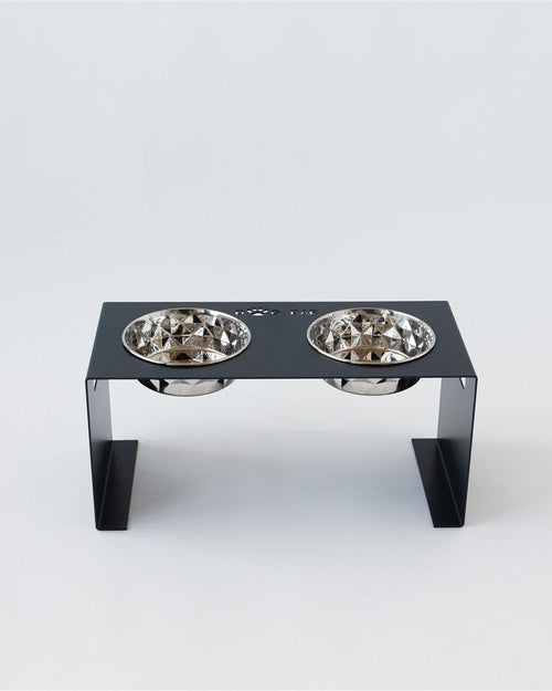 Pet feeding station with two bowls on a white background