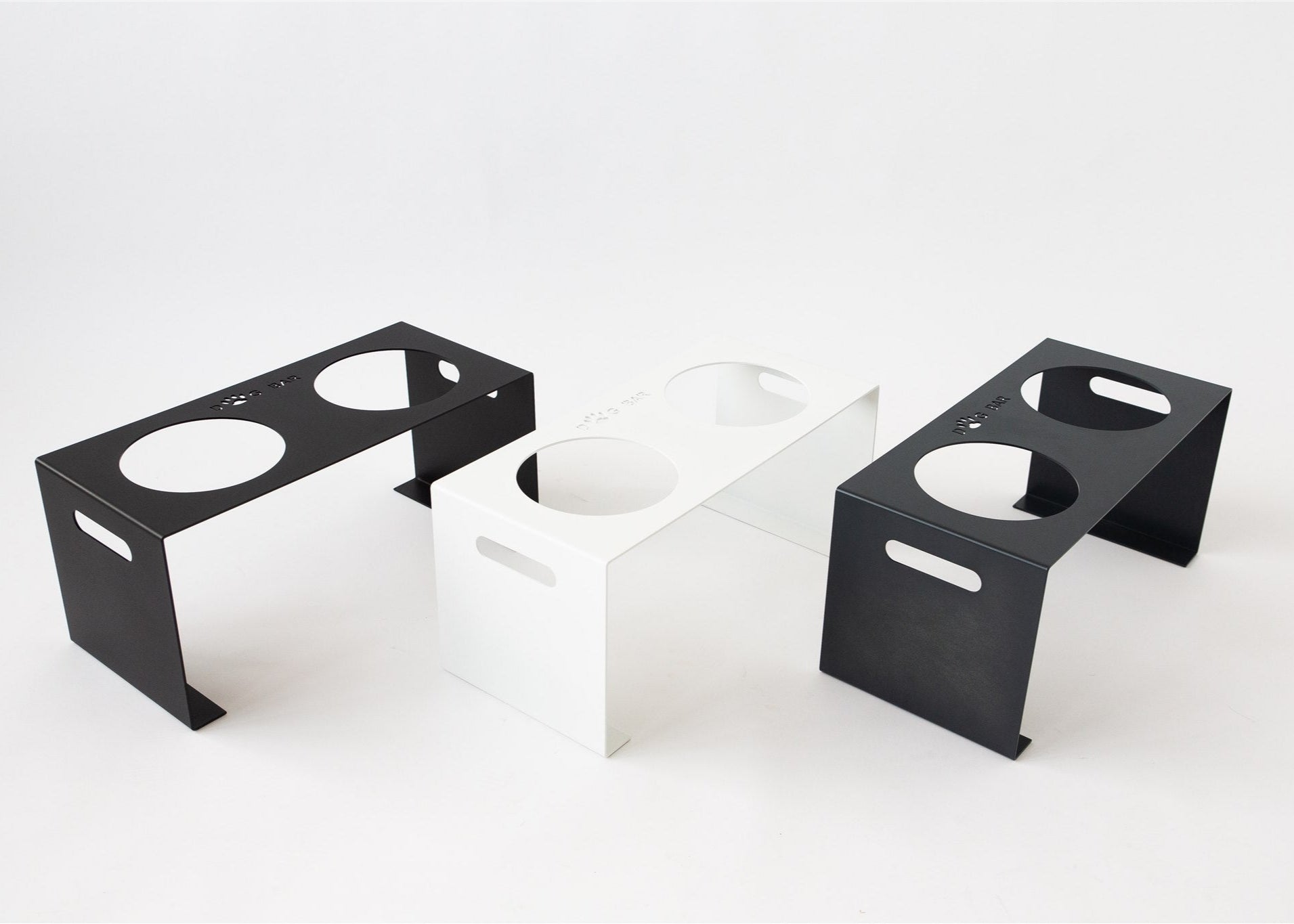 Three black and white ceramic sinks on a white background