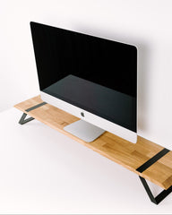 Computer monitor on a wooden desk with a white background