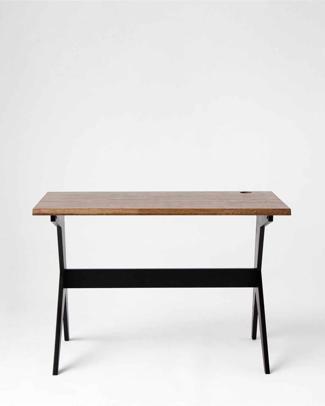 Wooden desk with black legs on a white background