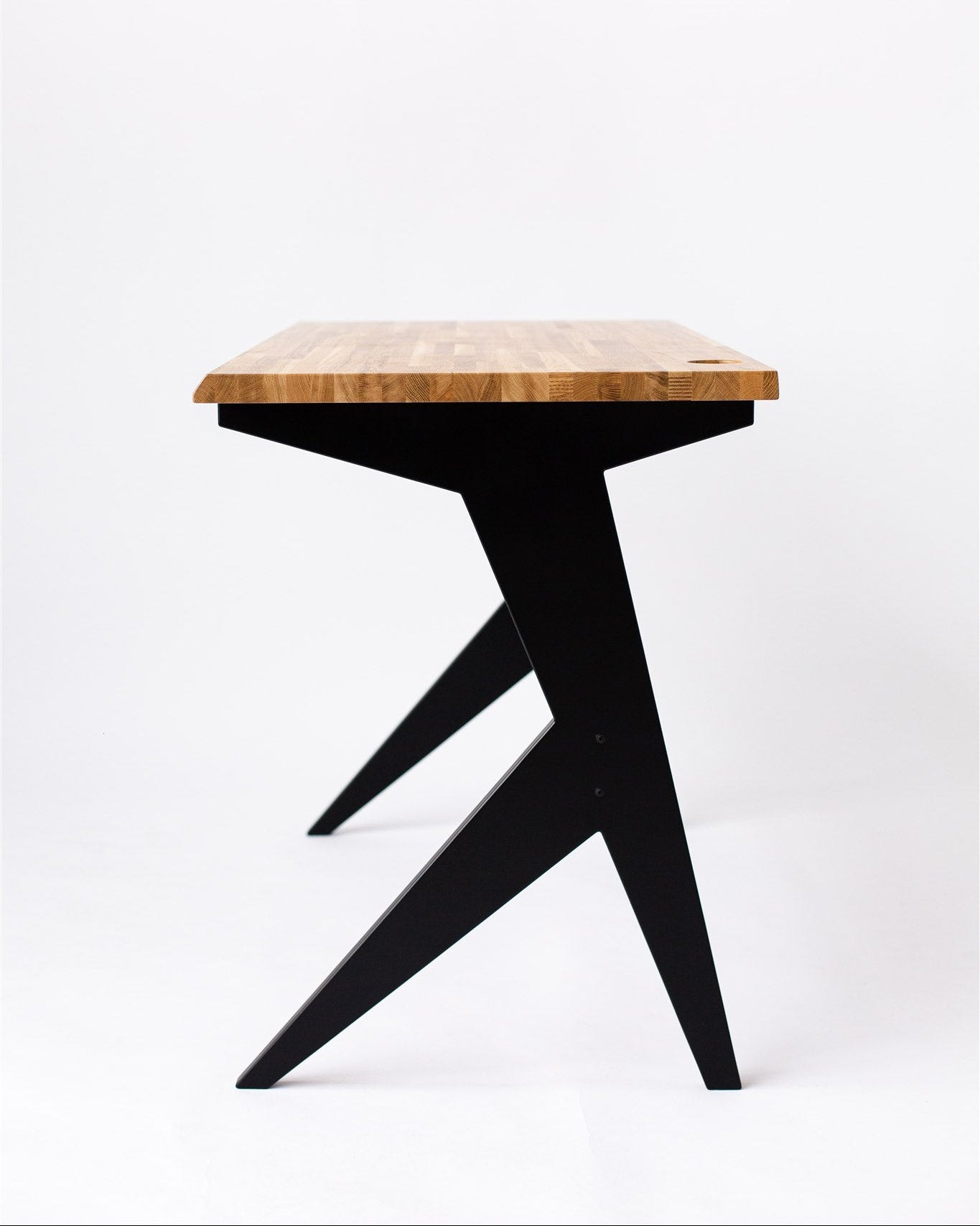 Small wooden table with black legs on a white background