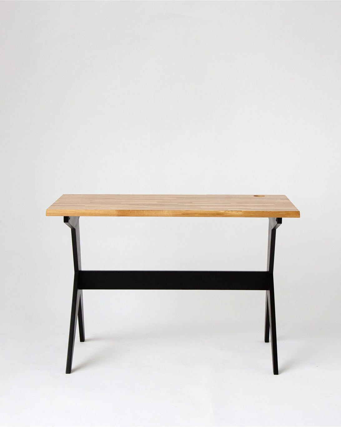 Wooden table with black legs on a white background