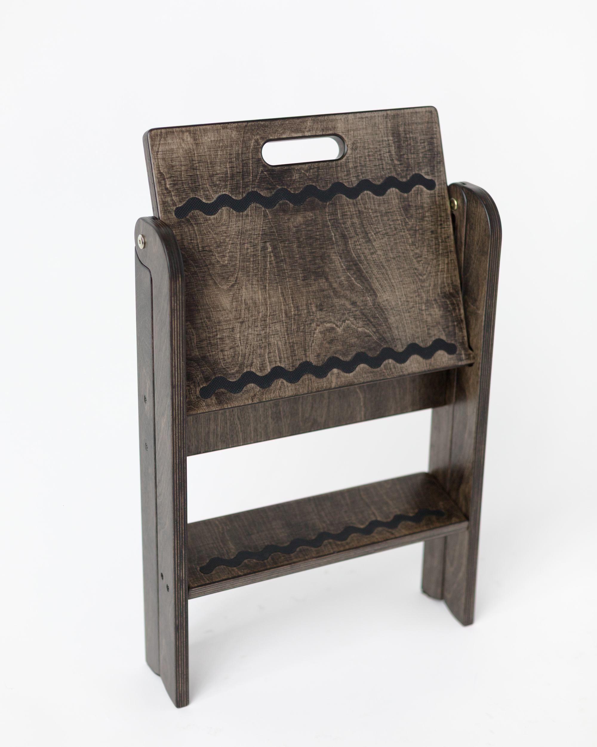 Wooden stool with a textured surface and handle on a white background
