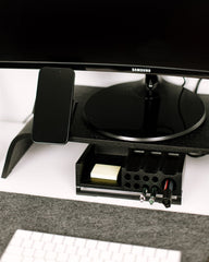 Samsung monitor on a desk with a phone and keyboard in the foreground