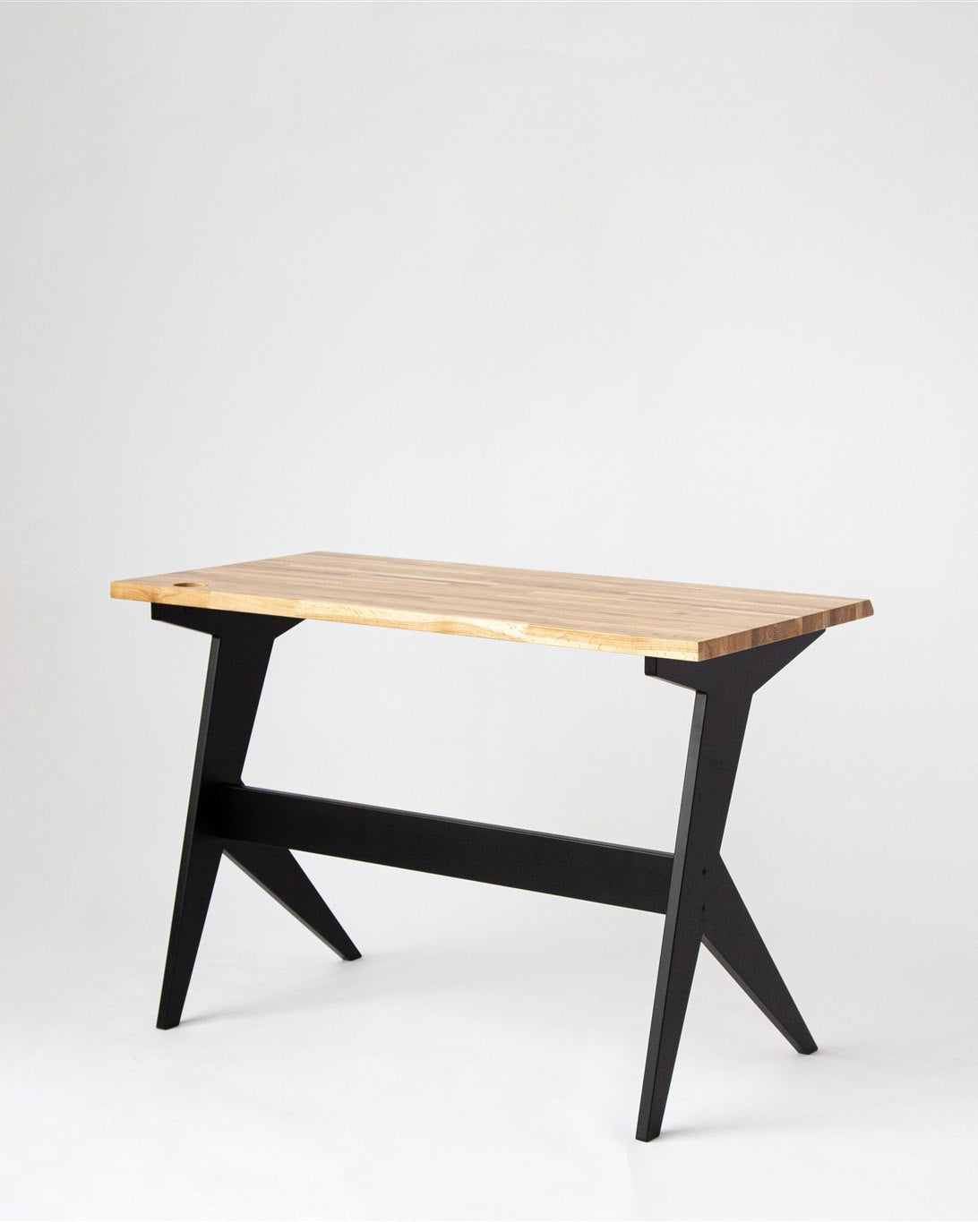 Wooden table with black legs on a white background
