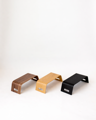 Three wooden stands in different colors on a white background