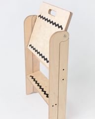 Wooden climbing toy with a white board on a light gray background