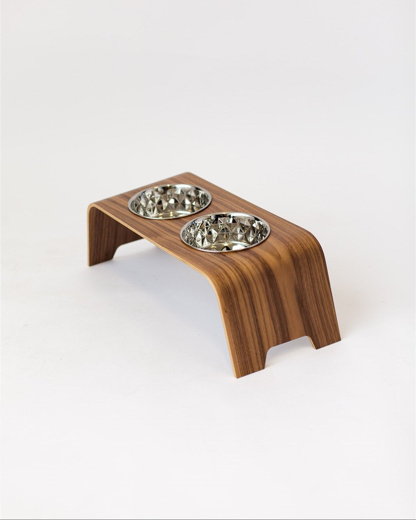 Wooden pet feeder with two bowls on a white background