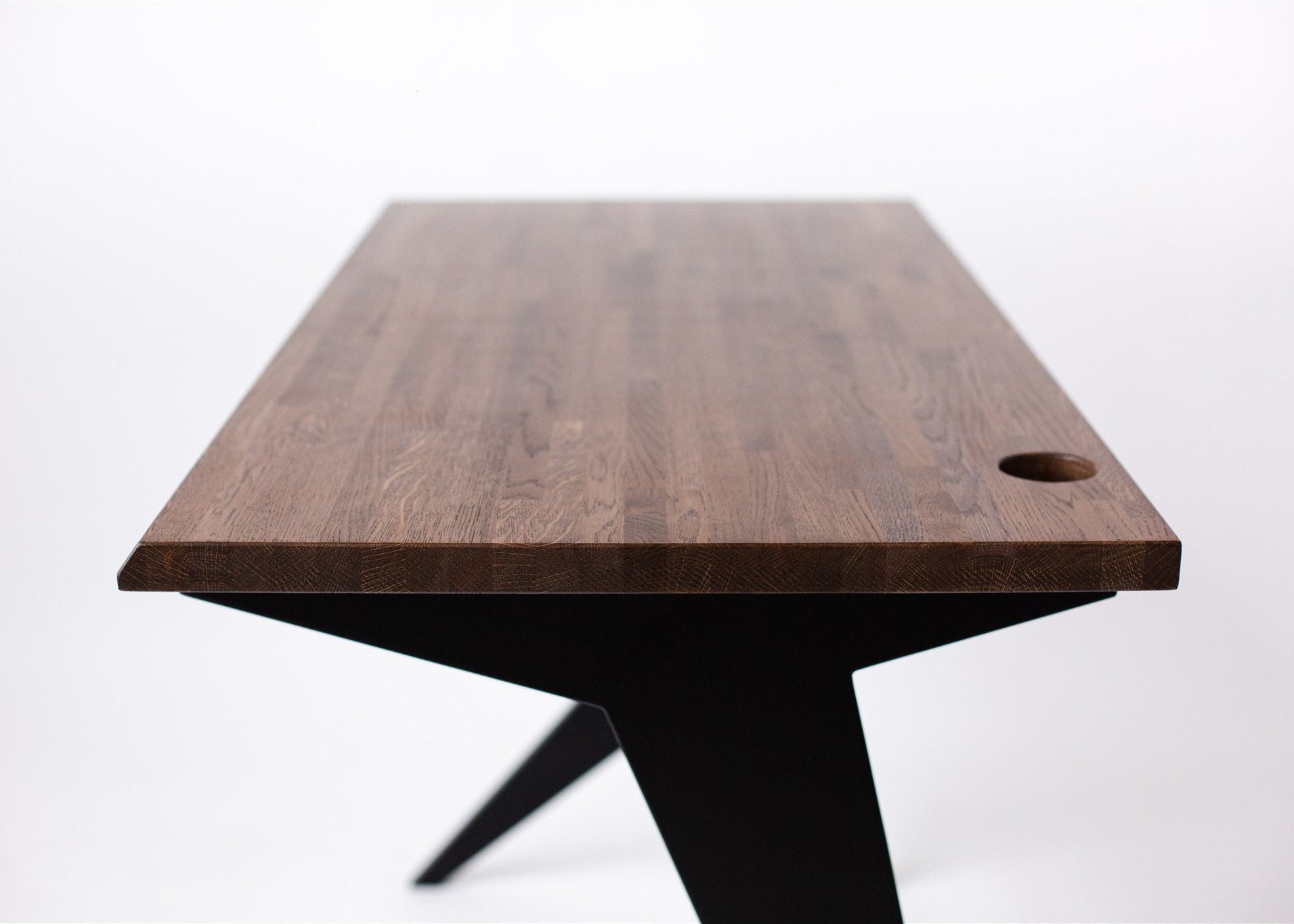 Wooden table with a single hole on a white background