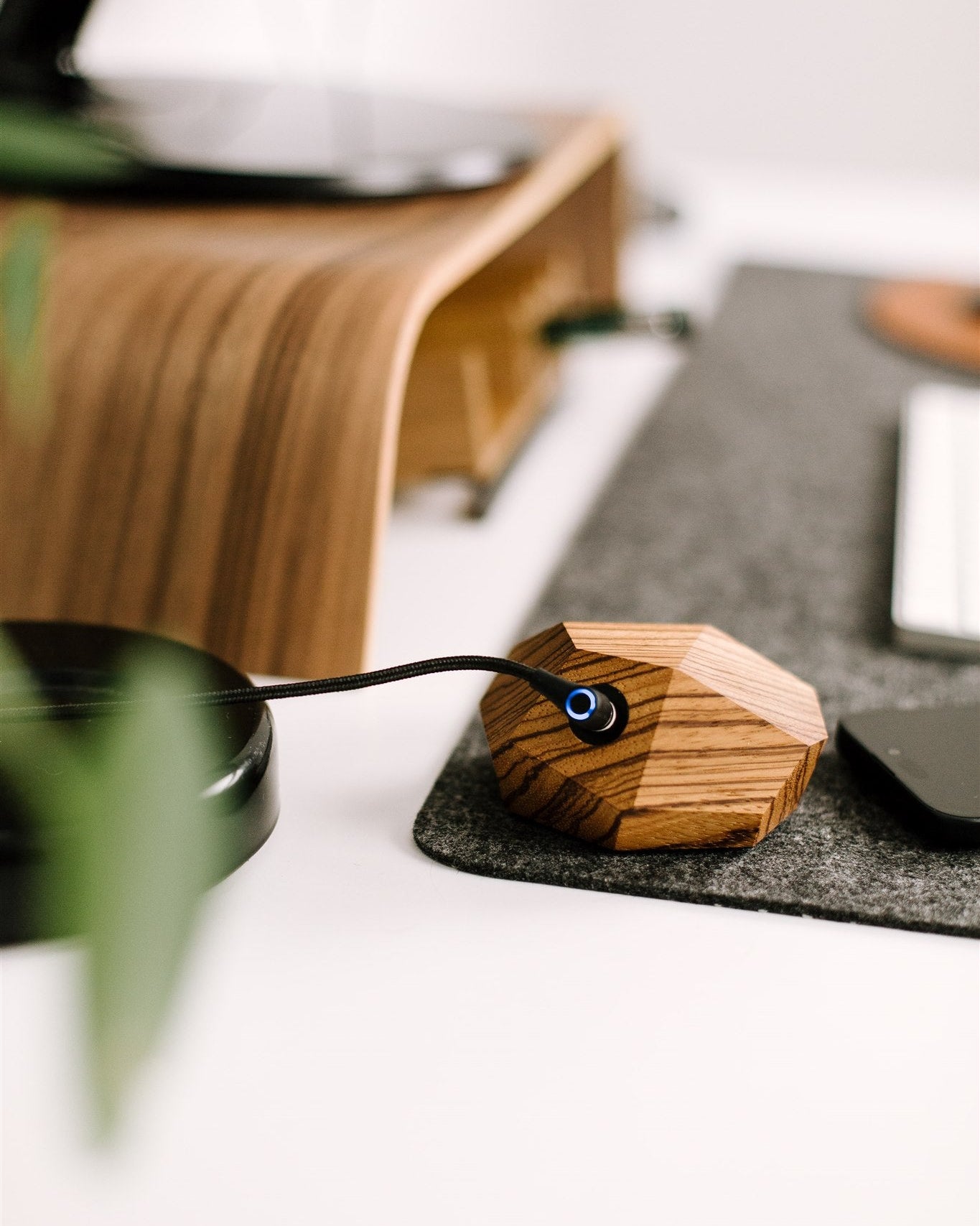Wooden magsafe charger from zebrano on a desk with a blurred background